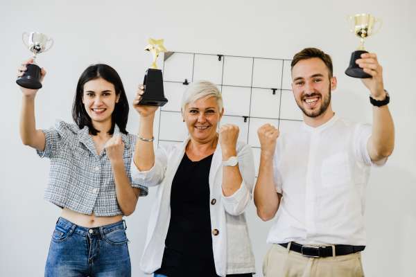 Businessman Team Holding Award Trophy for Show